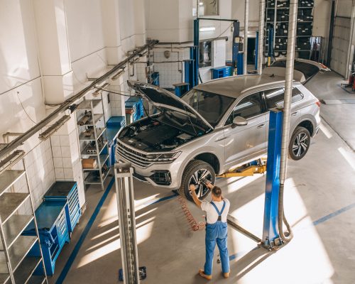 Auto mechanic checking car